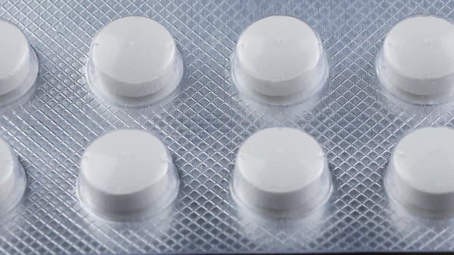 Close up Pills and drugs. Medicine, pills and tablets with blister packs turning.