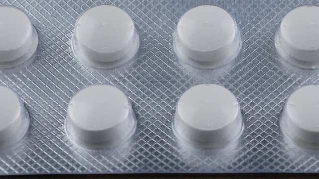 Close up Pills and drugs. Medicine, pills and tablets with blister packs turning.