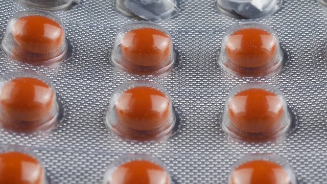 Close up Pills and drugs. Medicine, pills and tablets with blister packs turning.