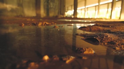 THROWING A STONE TO A DEVASTATED GROUND FULL OF BROWN MUD