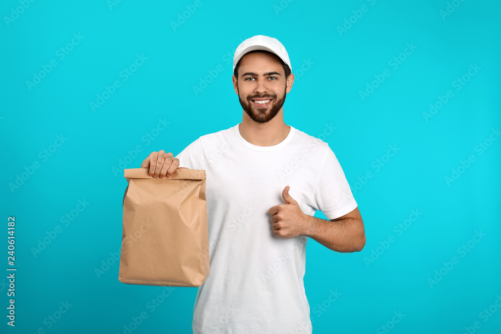 Sticker Young courier with paper bag on color background. Food delivery service