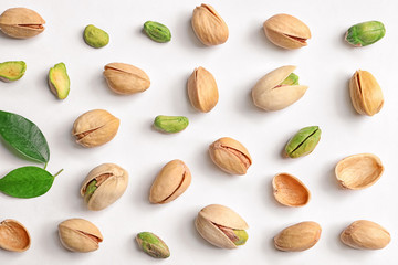 Organic pistachio nuts on white background, flat lay