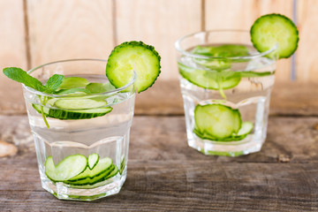 Cucumber water. Summer cool water with mint on table