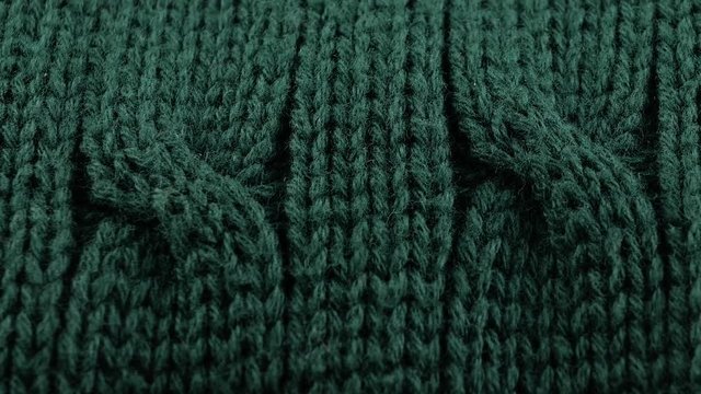 Pigtails on Green Knitwear Fabric Texture. Machine Knitting Texture Macro Snapshot.