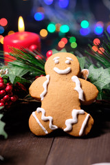 ginger biscuit and marshmallow on brown background with Christmas tree ,  candles and christmas lights