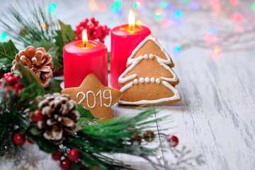 ginger biscuit and marshmallow on white background with Christmas tree ,  candles and christmas lights