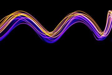 Long exposure light painting photography, curvy swirl of vibrant neon pink and metallic yellow gold against a black background