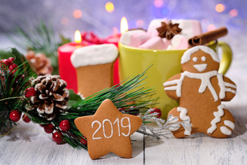 ginger biscuit and marshmallow on white background with Christmas tree ,  candles and christmas lights