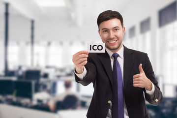 Business, technology, internet and networking concept. Young entrepreneur showing keyword: ICO