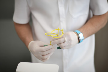 The dental assistant holds the positioner x-ray film holder in the dental clinic