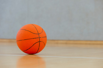 Basketball on a hardwood court floor as a sports and fitness symbol of a team leisure activity...