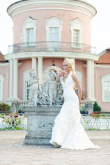 Bride blonde in a luxurious wedding dress