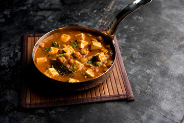 Chole Paneer curry made using boiled chickpea with cottage cheese with spices. Popular North Indian recipe. served in a bowl or serving pan. Selective focus