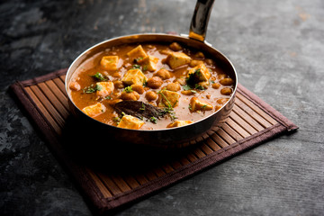 Chole Paneer curry made using boiled chickpea with cottage cheese with spices. Popular North Indian recipe. served in a bowl or serving pan. Selective focus