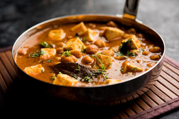 Chole Paneer curry made using boiled chickpea with cottage cheese with spices. Popular North Indian recipe. served in a bowl or serving pan. Selective focus