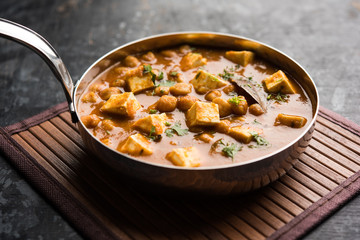 Chole Paneer curry made using boiled chickpea with cottage cheese with spices. Popular North Indian recipe. served in a bowl or serving pan. Selective focus