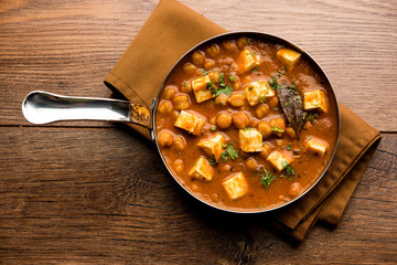 Chole Paneer curry made using boiled chickpea with cottage cheese with spices. Popular North Indian recipe. served in a bowl or serving pan. Selective focus