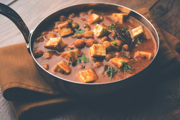 Chole Paneer curry made using boiled chickpea with cottage cheese with spices. Popular North Indian recipe. served in a bowl or serving pan. Selective focus