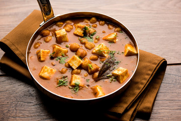 Chole Paneer curry made using boiled chickpea with cottage cheese with spices. Popular North Indian recipe. served in a bowl or serving pan. Selective focus