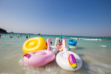 Life rubber rings with seascape in Koh Larn island, Pattaya, Thailand. Small tropical beach with lot of tourist, white sand and blue sea, perfect for traveling.