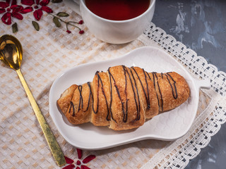 Light breakfast with chocolate croissant and tea