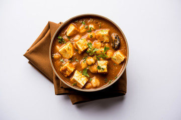 Chole Paneer curry made using boiled chickpea with cottage cheese with spices. Popular North Indian recipe. served in a bowl or serving pan. Selective focus