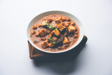 Chole Paneer curry made using boiled chickpea with cottage cheese with spices. Popular North Indian recipe. served in a bowl or serving pan. Selective focus
