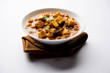 Chole Paneer curry made using boiled chickpea with cottage cheese with spices. Popular North Indian recipe. served in a bowl or serving pan. Selective focus