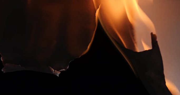 Pre-keyed alpha channel white paper on fire on transparent background.