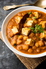 Chole Paneer curry made using boiled chickpea with cottage cheese with spices. Popular North Indian recipe. served in a bowl or serving pan. Selective focus