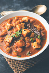 Chole Paneer curry made using boiled chickpea with cottage cheese with spices. Popular North Indian recipe. served in a bowl or serving pan. Selective focus