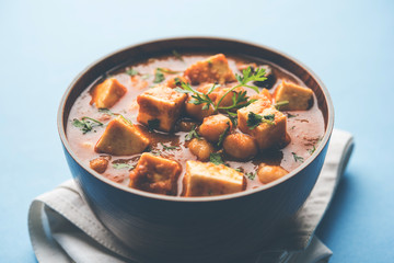 Chole Paneer curry made using boiled chickpea with cottage cheese with spices. Popular North Indian recipe. served in a bowl or serving pan. Selective focus