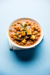 Chole Paneer curry made using boiled chickpea with cottage cheese with spices. Popular North Indian recipe. served in a bowl or serving pan. Selective focus