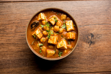 Chole Paneer curry made using boiled chickpea with cottage cheese with spices. Popular North Indian recipe. served in a bowl or serving pan. Selective focus