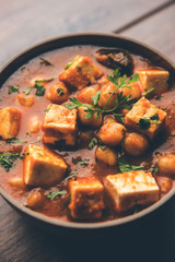 Chole Paneer curry made using boiled chickpea with cottage cheese with spices. Popular North Indian recipe. served in a bowl or serving pan. Selective focus