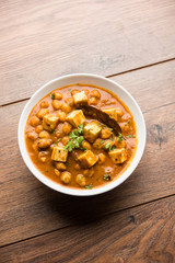 Chole Paneer curry made using boiled chickpea with cottage cheese with spices. Popular North Indian recipe. served in a bowl or serving pan. Selective focus