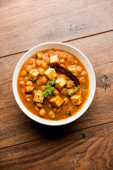 Chole Paneer curry made using boiled chickpea with cottage cheese with spices. Popular North Indian recipe. served in a bowl or serving pan. Selective focus