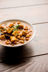 Chole Paneer curry made using boiled chickpea with cottage cheese with spices. Popular North Indian recipe. served in a bowl or serving pan. Selective focus