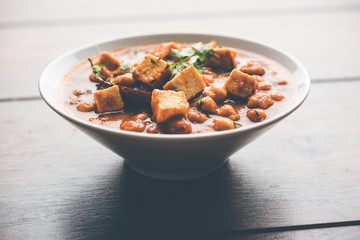 Chole Paneer curry made using boiled chickpea with cottage cheese with spices. Popular North Indian recipe. served in a bowl or serving pan. Selective focus