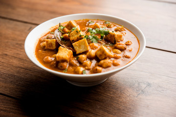 Chole Paneer curry made using boiled chickpea with cottage cheese with spices. Popular North Indian recipe. served in a bowl or serving pan. Selective focus
