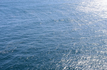 Fototapeta na wymiar Top view of an ocean, background texture, sunlight reflecting off the water
