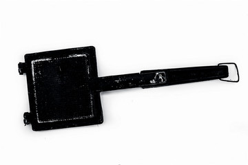 Close up of metal hand toaster used to toast sandwiches and breads or other edibles isolated on white.