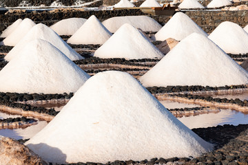 Salt piles on a saline exploration in salt factory refinery mines Janubio, Lanzarote, Canary...
