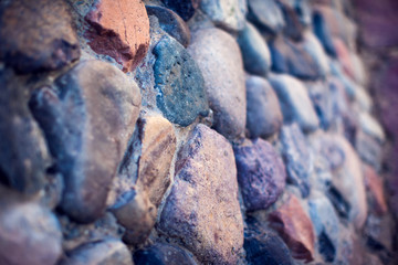 Natural colorful pebbles wall on beach in summer