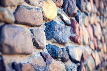 Natural colorful pebbles wall on beach in summer