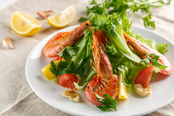 fresh salad with grilled shrimps with spices and tomatoes