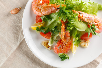 fresh salad with grilled shrimps with spices and tomatoes