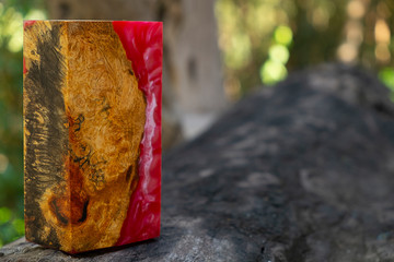 casting epoxy resin Stabilizing Afzelia burl exotic wood red yellow background, Abstract art picture photo, print design and your advertisement, hybrid