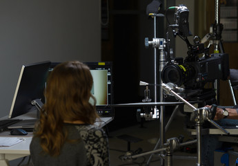 Behind the scenes of the camera when shooting a film, advertisement, video, team, actors. Shooting place, side view, focus on the hand with a raised finger