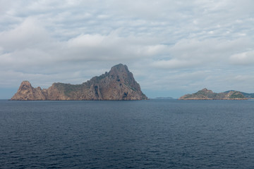 The island of es vedra from behind from a boat